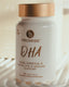 Bottle of Promise DHA Omega-3 supplement on a white surface with a blurred background