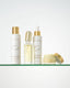 Set of skincare products on a glass shelf with a white background